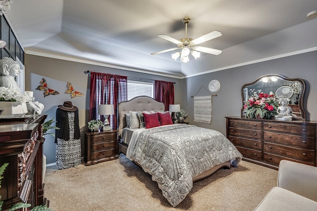 bedroom with ornamental molding, carpet, and a ceiling fan