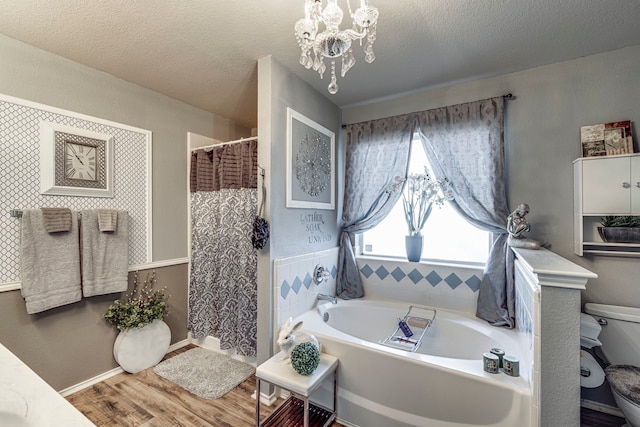 bathroom featuring a garden tub, a notable chandelier, curtained shower, a textured ceiling, and wood finished floors