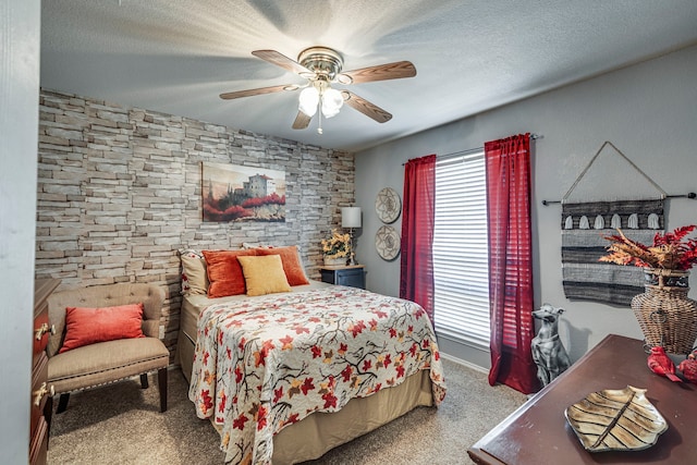 bedroom featuring carpet floors, ceiling fan, and a textured ceiling