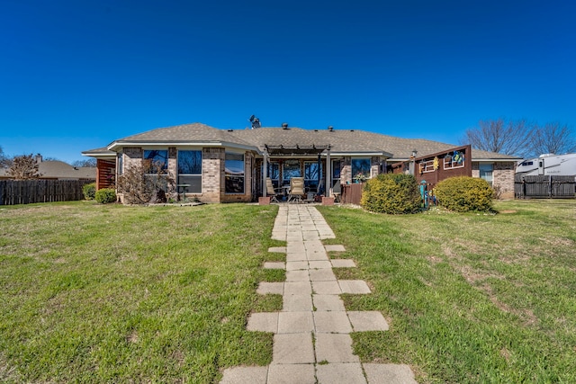 rear view of house with brick siding, fence, a lawn, and a pergola