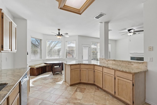 kitchen with dishwasher, a ceiling fan, visible vents, and light stone counters