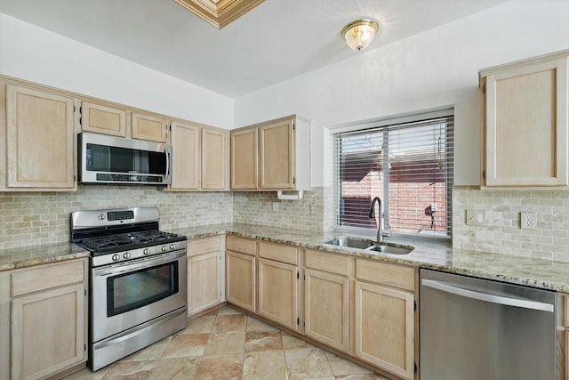 kitchen featuring a sink, stainless steel appliances, and light brown cabinets