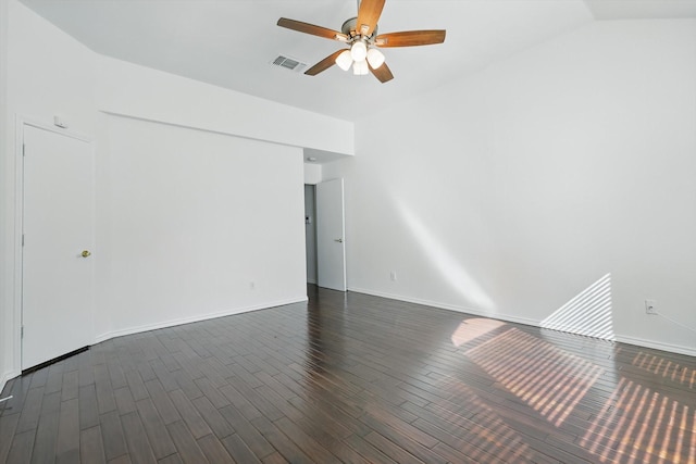 spare room featuring lofted ceiling, visible vents, dark wood-type flooring, ceiling fan, and baseboards