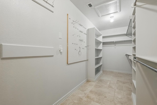 spacious closet with attic access and visible vents