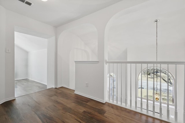 empty room with visible vents and wood finished floors