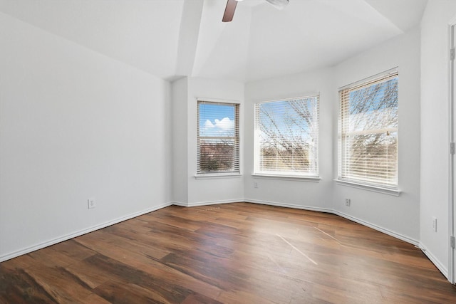 unfurnished room with vaulted ceiling, ceiling fan, baseboards, and wood finished floors