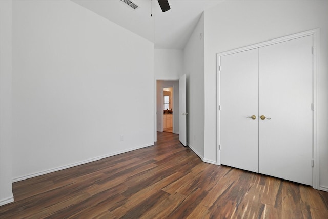 unfurnished bedroom with high vaulted ceiling, wood finished floors, visible vents, a ceiling fan, and baseboards