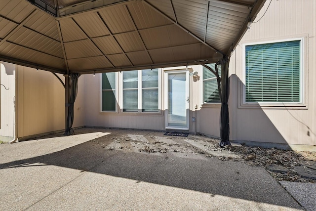 doorway to property featuring a carport and a patio area