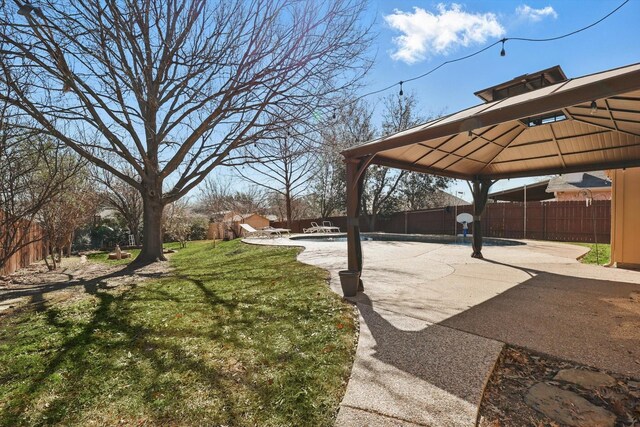 view of yard with a fenced in pool, a patio area, a fenced backyard, and a gazebo