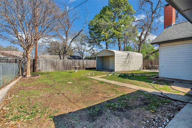 view of yard featuring an outbuilding, a fenced backyard, and a storage shed