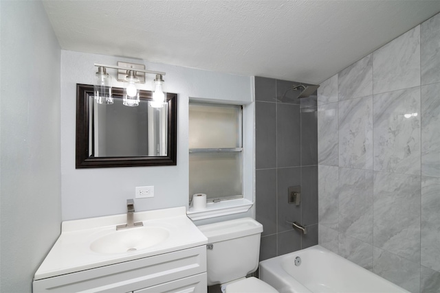 bathroom with tub / shower combination, toilet, vanity, and a textured ceiling