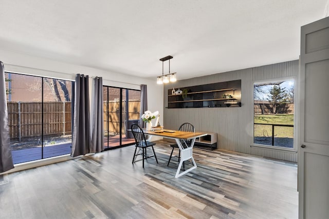 dining area with plenty of natural light and wood finished floors