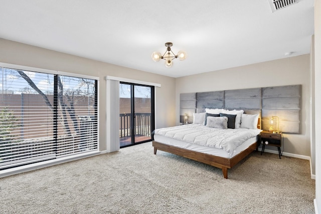 carpeted bedroom featuring access to exterior, baseboards, visible vents, and an inviting chandelier