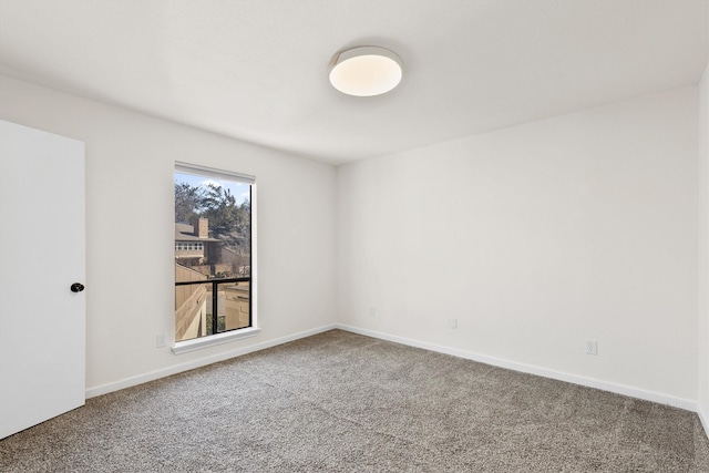 carpeted empty room with baseboards