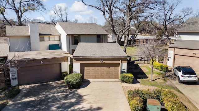 townhome / multi-family property with a garage, concrete driveway, roof with shingles, and stucco siding