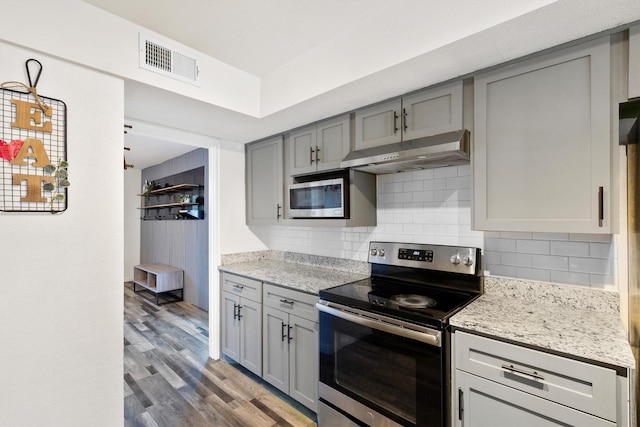 kitchen with gray cabinetry, appliances with stainless steel finishes, visible vents, and under cabinet range hood