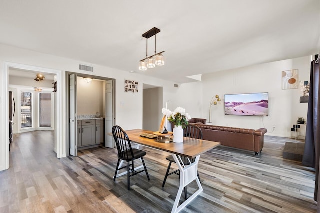 dining room with visible vents and wood finished floors