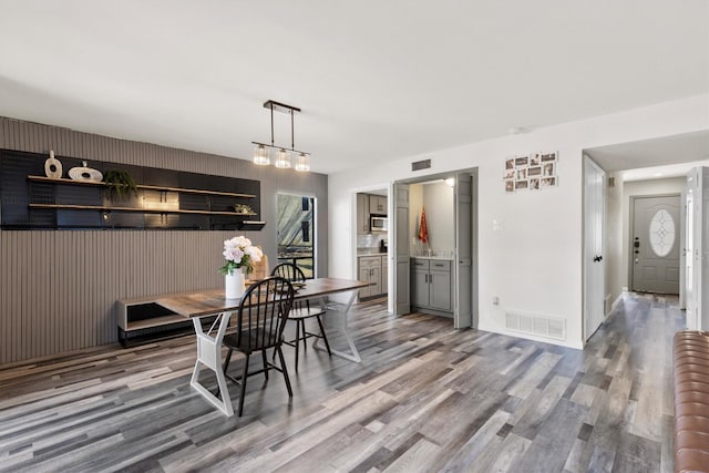 dining area featuring wood finished floors and visible vents