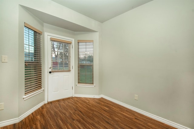 interior space with wood finished floors and baseboards