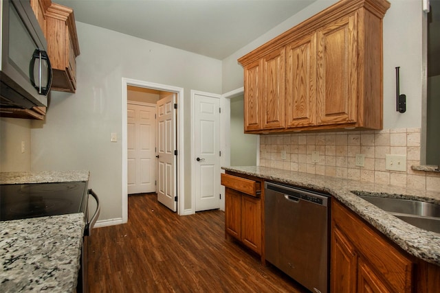 kitchen featuring light stone counters, decorative backsplash, dark wood-type flooring, and dishwasher