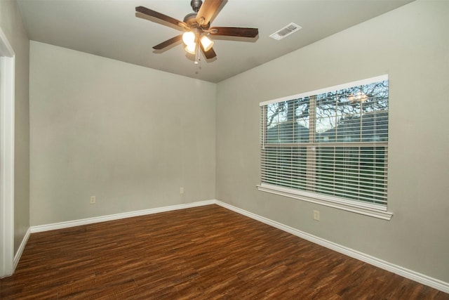 empty room with baseboards, visible vents, ceiling fan, and wood finished floors