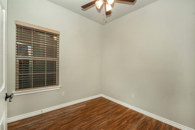 empty room featuring a ceiling fan, baseboards, and wood finished floors