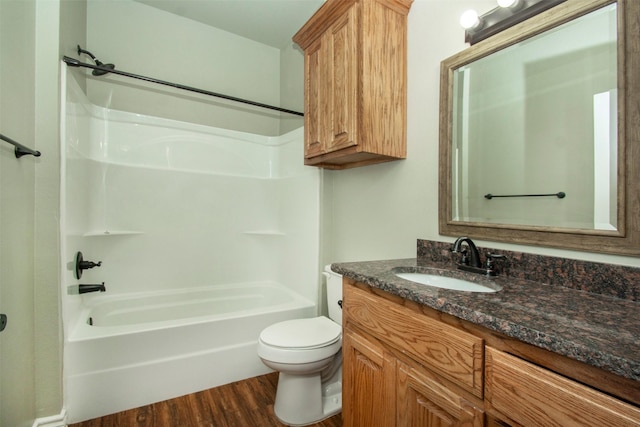 full bath featuring toilet, bathing tub / shower combination, wood finished floors, and vanity