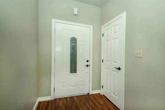 doorway to outside with dark wood finished floors and baseboards