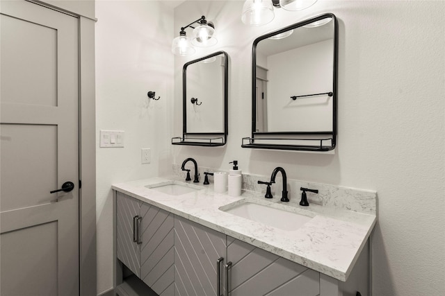 bathroom featuring a sink and double vanity