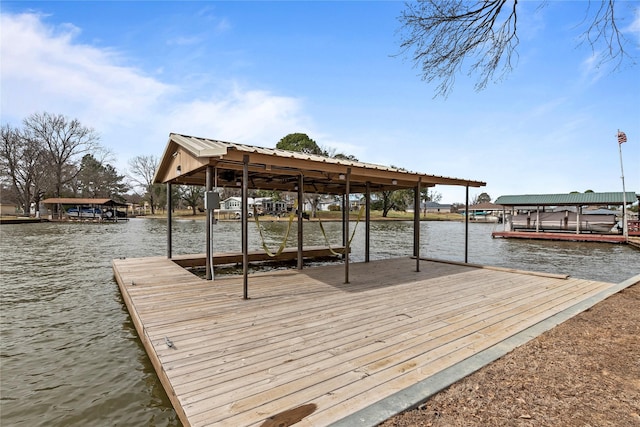 dock area with a water view and boat lift