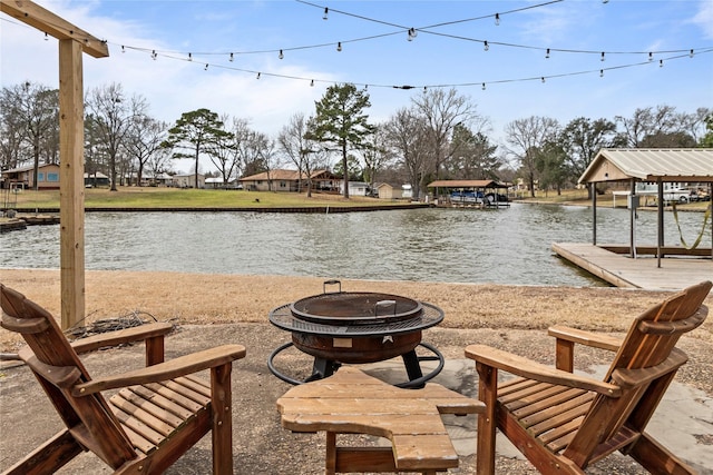 exterior space featuring a fire pit and a water view