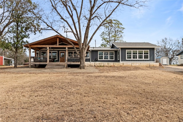 rear view of property with a storage shed, board and batten siding, and an outdoor structure