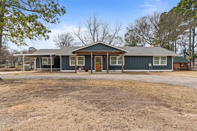 ranch-style house featuring board and batten siding, roof with shingles, and a chimney