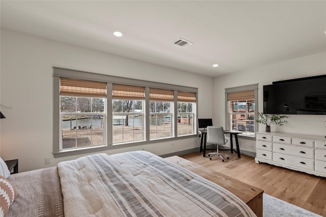 bedroom with light wood-type flooring, visible vents, baseboards, and recessed lighting