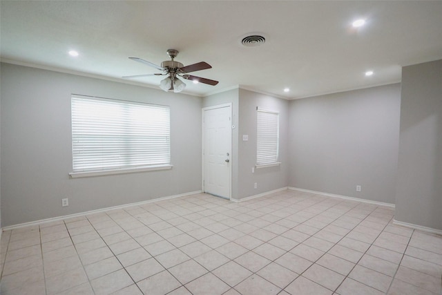 empty room with baseboards, visible vents, crown molding, and recessed lighting