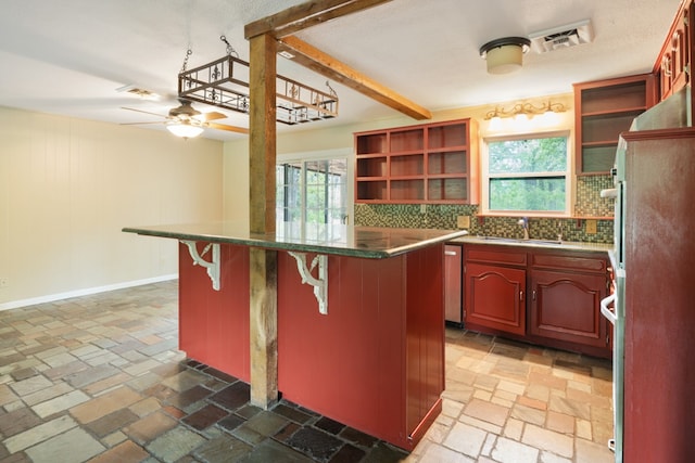 114 Adelia Dr, Mabank, TX 75156 - kitchen featuring stone tile flooring, a sink, a kitchen breakfast bar, and open shelves