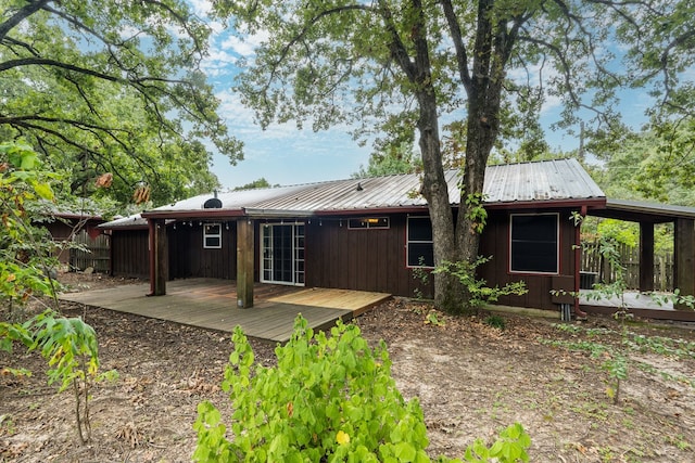114 Adelia Dr, Mabank, TX 75156 - rear view of property with metal roof, board and batten siding, and a wooden deck