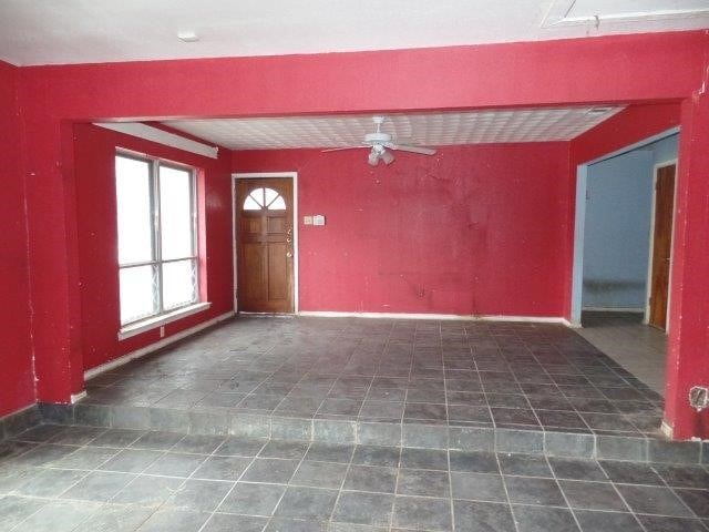 interior space featuring ceiling fan