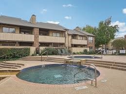 view of swimming pool with a hot tub