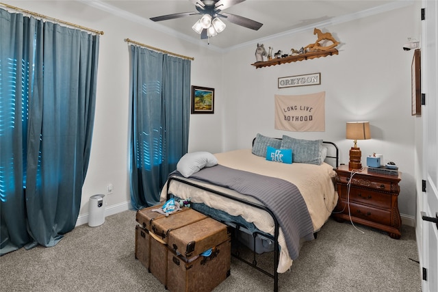 carpeted bedroom featuring ornamental molding, a ceiling fan, and baseboards