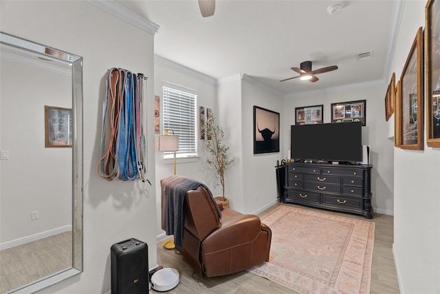 sitting room featuring ceiling fan, ornamental molding, and visible vents