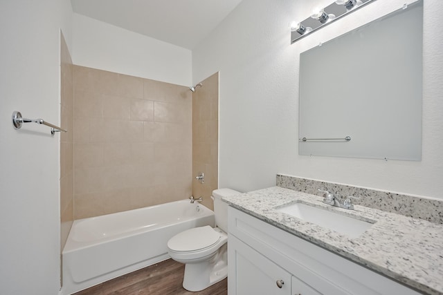 bathroom with vanity, shower / bathing tub combination, wood finished floors, and toilet