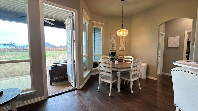 213 Stuart St, Paradise, TX 76073 - dining room featuring arched walkways, dark wood-style flooring, and ceiling fan