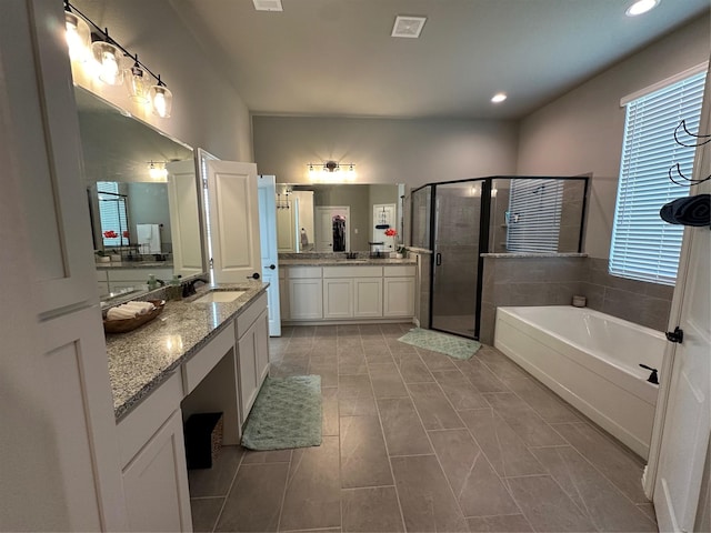 213 Stuart St, Paradise, TX 76073 - full bathroom with a stall shower, a garden tub, two vanities, and recessed lighting