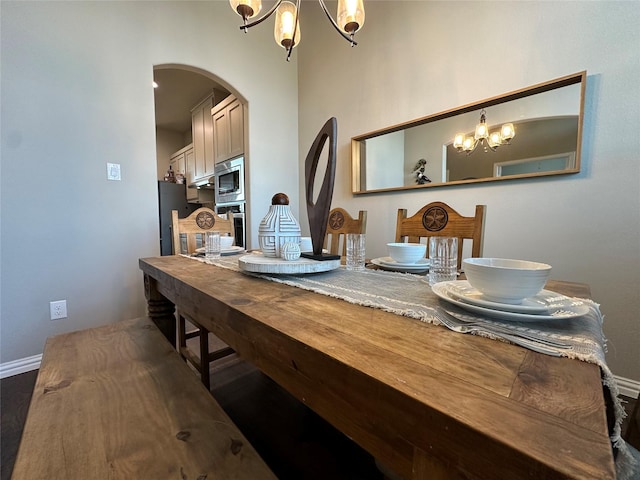 213 Stuart St, Paradise, TX 76073 - dining space with a chandelier, arched walkways, and wood finished floors