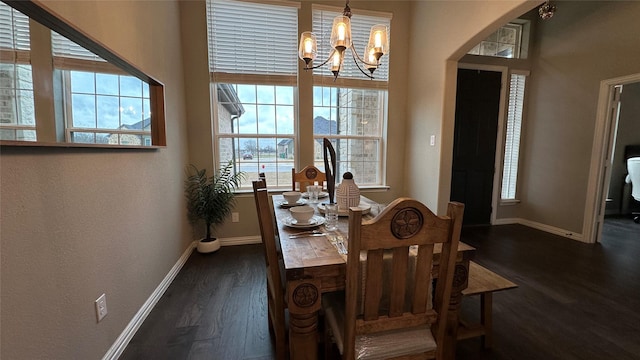 213 Stuart St, Paradise, TX 76073 - dining area featuring a chandelier, baseboards, wood finished floors, and healthy amount of natural light