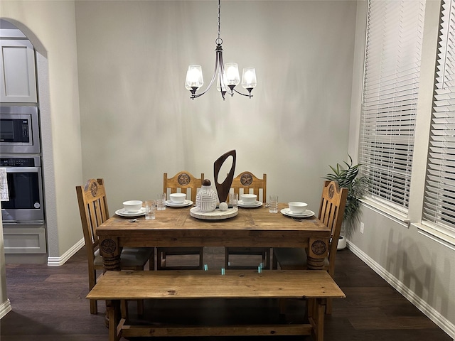 213 Stuart St, Paradise, TX 76073 - dining space with a chandelier, arched walkways, and wood finished floors