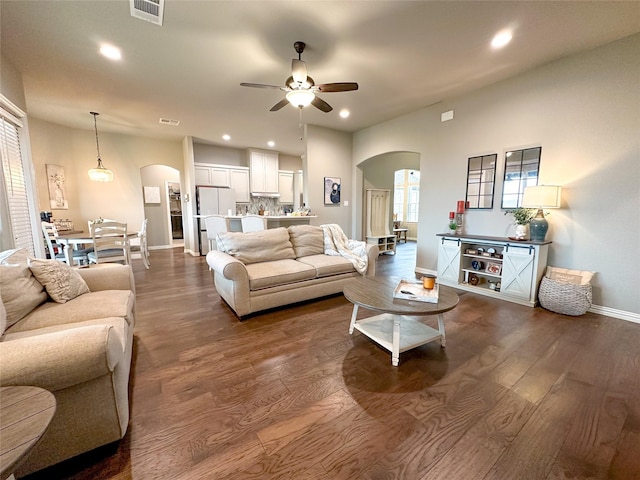 213 Stuart St, Paradise, TX 76073 - living room featuring arched walkways, a ceiling fan, dark wood-type flooring, and recessed lighting