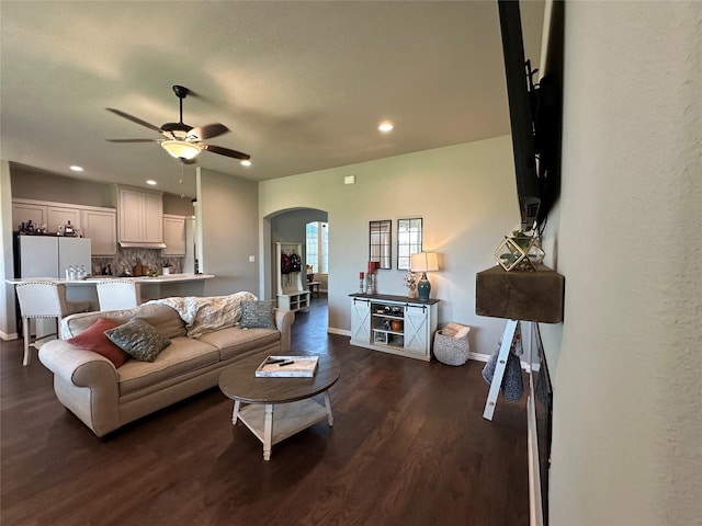 213 Stuart St, Paradise, TX 76073 - living area featuring arched walkways, ceiling fan, dark wood-style flooring, and recessed lighting
