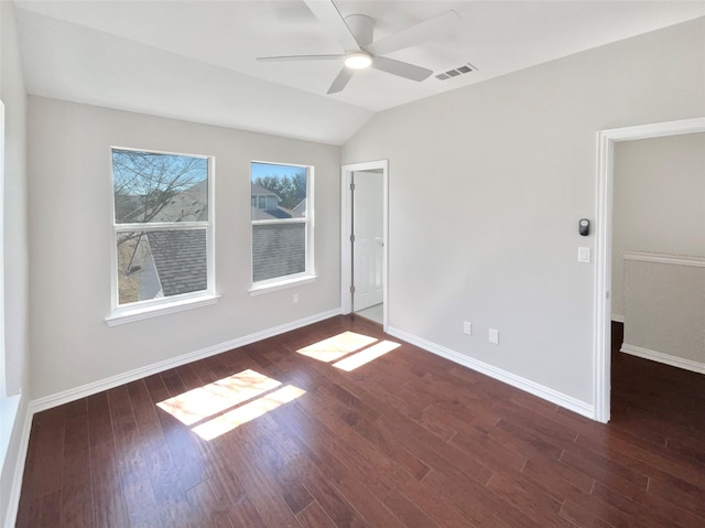 unfurnished bedroom with visible vents, a ceiling fan, vaulted ceiling, wood finished floors, and baseboards